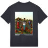 Back of a black t-shirt with artwork of a giant humans standing in a filed chained to the floor. they have houses wrapped around their torso like a t-shirt.